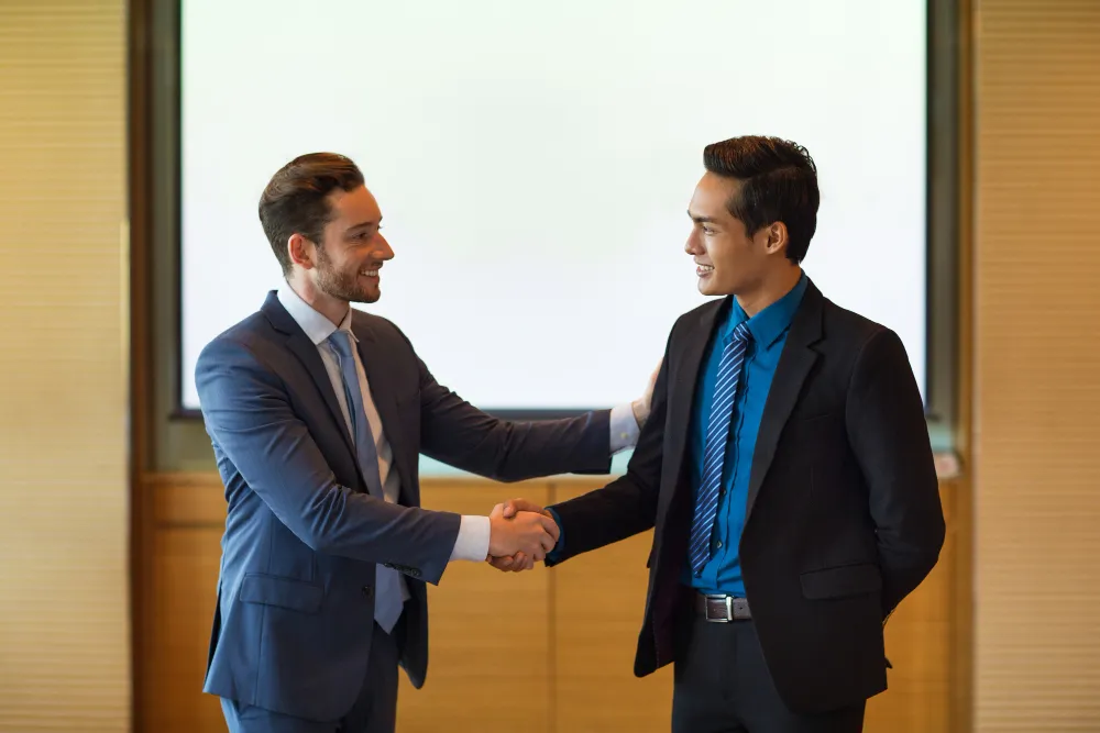 smiling-business-leader-greeting-partner